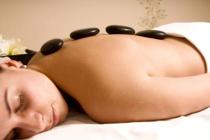 Luxe Massage Hot Stones on client's back.